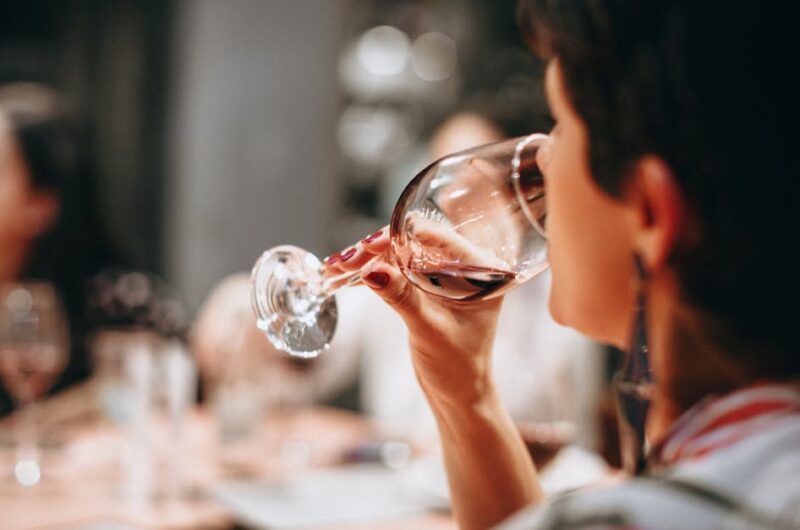 a group of adults enjoying wine together indoors in a warm social setting